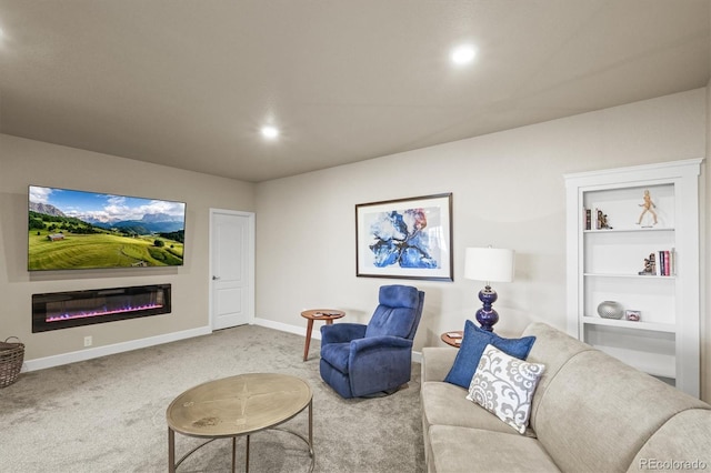 carpeted living room featuring a glass covered fireplace, built in shelves, recessed lighting, and baseboards