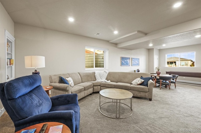 living area with recessed lighting, visible vents, and light carpet