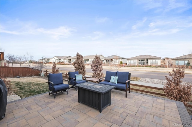 view of patio / terrace with outdoor lounge area, fence, and a residential view