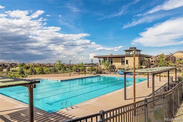 community pool featuring a patio and fence