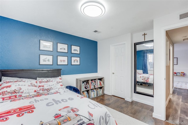 bedroom with dark hardwood / wood-style flooring