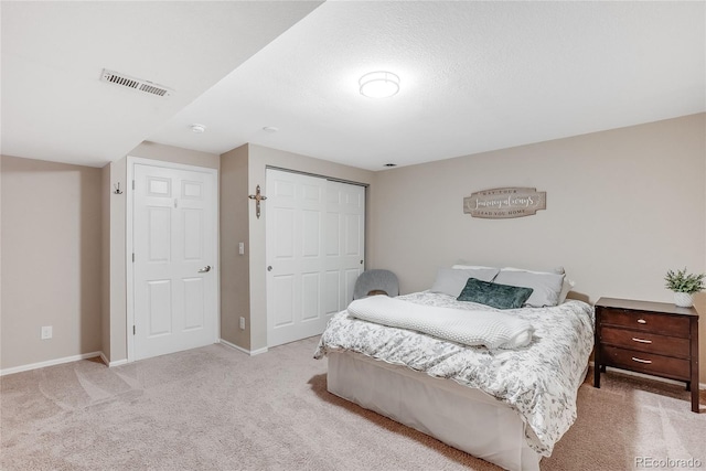 carpeted bedroom with a closet