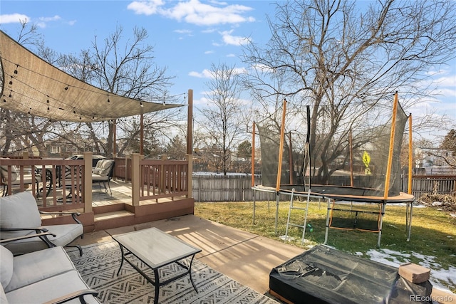 wooden deck with a trampoline