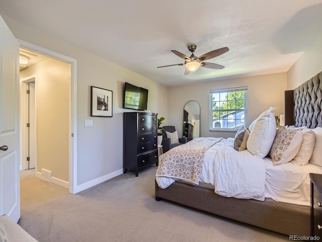 4196 S Reading Way, Denver, CO 80237 - bedroom featuring light carpet, baseboards, arched walkways, and a ceiling fan
