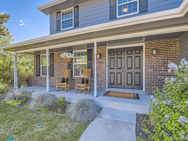 4196 S Reading Way, Denver, CO 80237 - property entrance featuring brick siding and a porch
