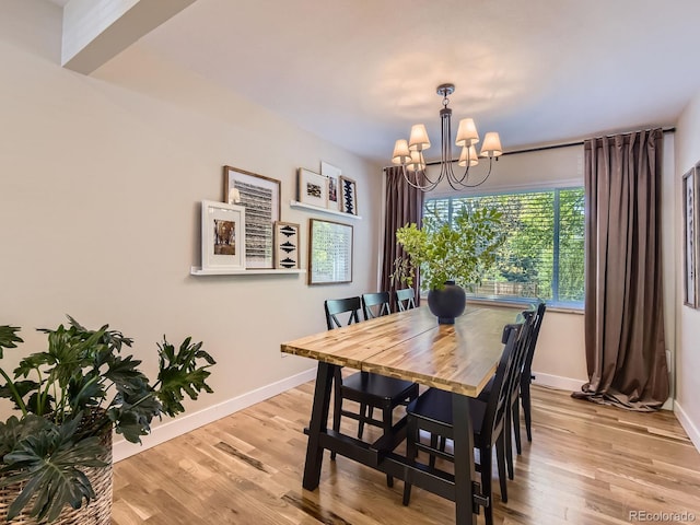 4196 S Reading Way, Denver, CO 80237 - dining room featuring a chandelier, baseboards, and light wood-style floors