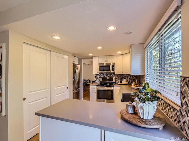 4196 S Reading Way, Denver, CO 80237 - kitchen featuring appliances with stainless steel finishes, a sink, tasteful backsplash, white cabinets, and recessed lighting