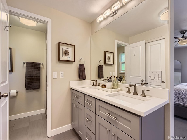 4196 S Reading Way, Denver, CO 80237 - bathroom with ensuite bath, baseboards, double vanity, and ceiling fan
