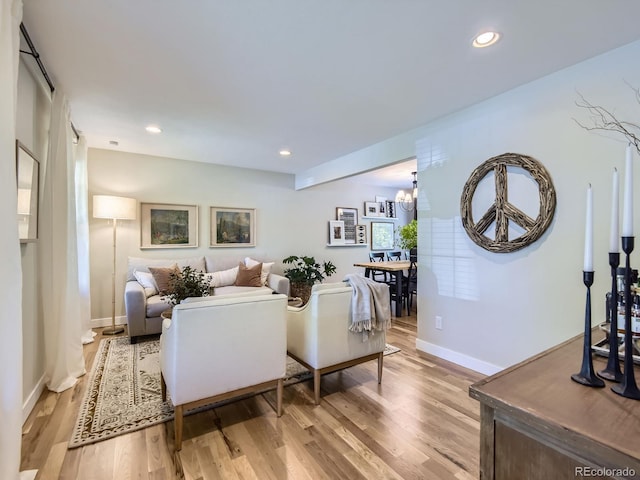 4196 S Reading Way, Denver, CO 80237 - living room featuring light wood-style floors, baseboards, recessed lighting, and a chandelier