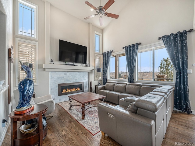 living room featuring ceiling fan, high vaulted ceiling, and dark hardwood / wood-style flooring