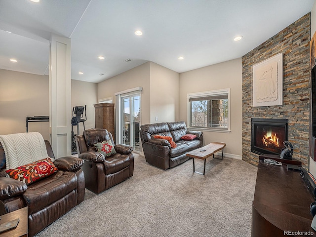 carpeted living room with a fireplace and a healthy amount of sunlight