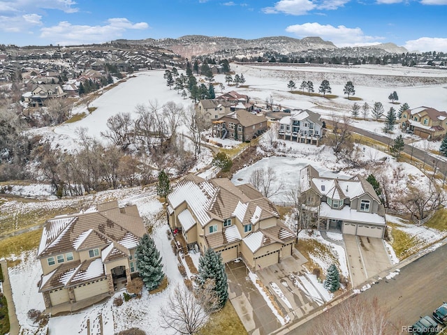 snowy aerial view featuring a mountain view