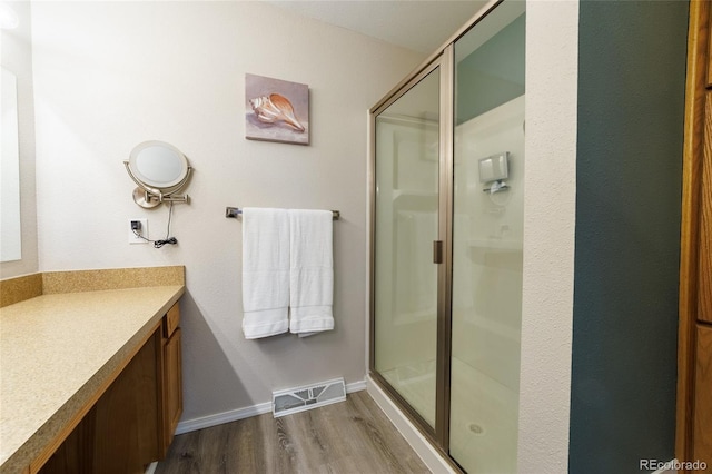 14347 E 134th Ave, Brighton, CO 80601 - full bath with wood finished floors, a shower stall, vanity, and baseboards
