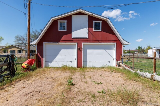 14347 E 134th Ave, Brighton, CO 80601 - garage featuring fence, a garage, and driveway