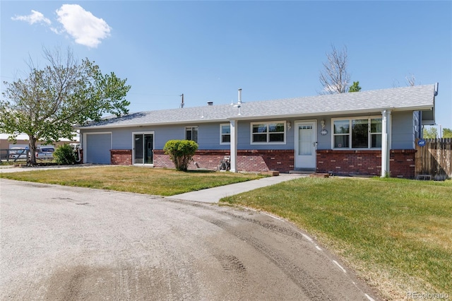 14347 E 134th Ave, Brighton, CO 80601 - single story home featuring an attached garage, brick siding, and driveway
