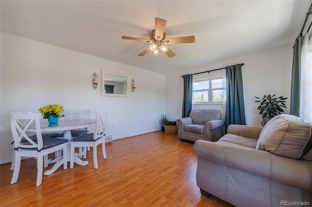 14347 E 134th Ave, Brighton, CO 80601 - living area featuring light wood-style flooring, ceiling fan, and baseboards