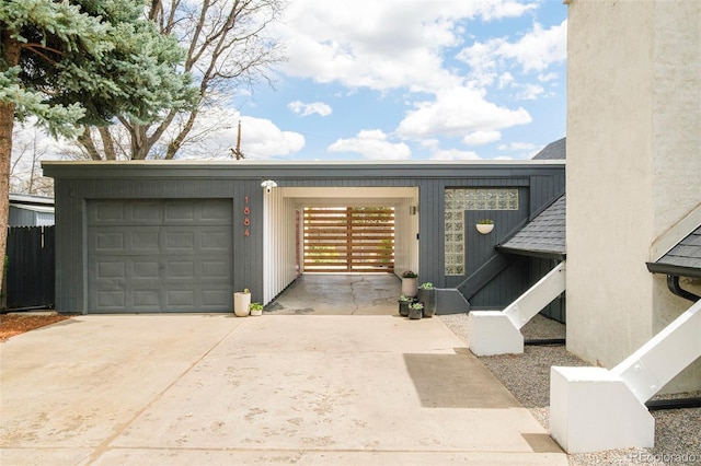 1884 S Ivy St, Denver, CO 80224 - view of front of house featuring driveway, a garage, and board and batten siding