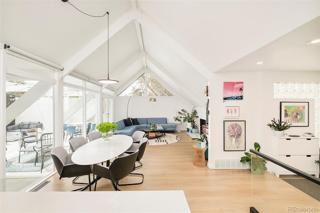 1884 S Ivy St, Denver, CO 80224 - dining space with light wood finished floors, beamed ceiling, and high vaulted ceiling