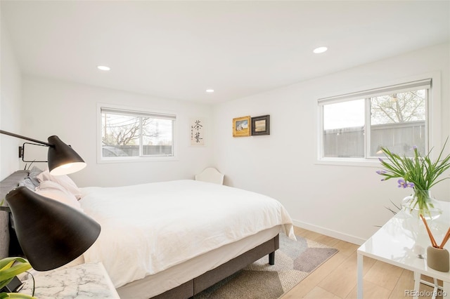 1884 S Ivy St, Denver, CO 80224 - bedroom featuring multiple windows, recessed lighting, baseboards, and wood finished floors