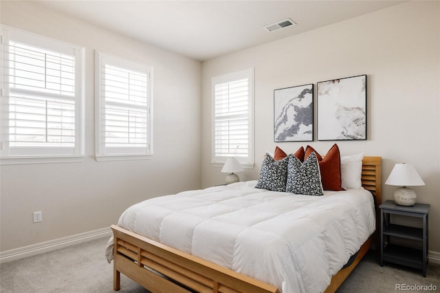 bedroom with baseboards, visible vents, and carpet floors