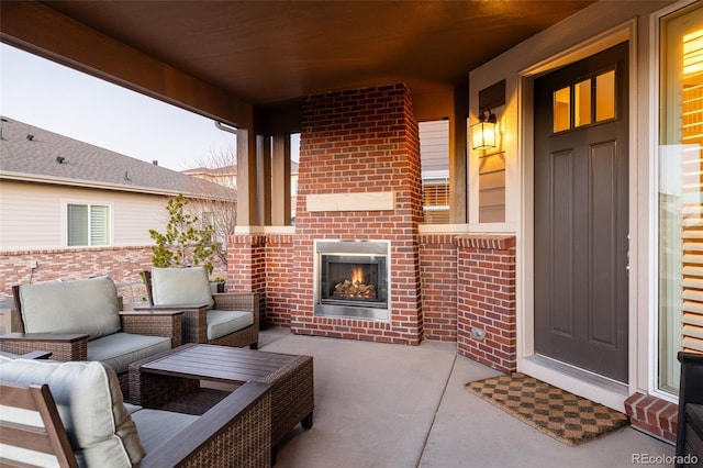 view of patio with an outdoor living space with a fireplace