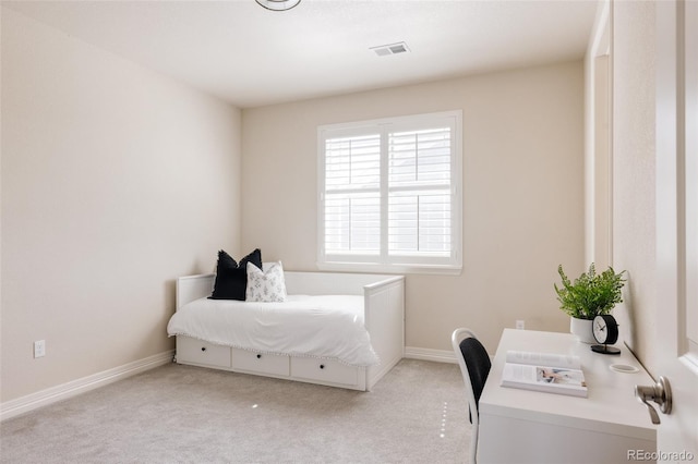 bedroom featuring baseboards, visible vents, and light carpet