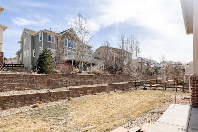 view of yard featuring a residential view and fence