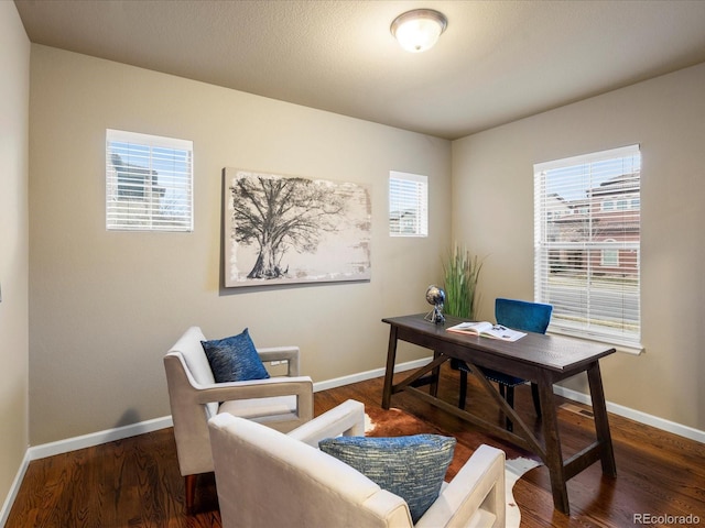 home office featuring baseboards, plenty of natural light, and wood finished floors