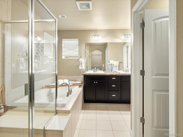 bathroom featuring visible vents, a garden tub, a stall shower, tile patterned floors, and a sink