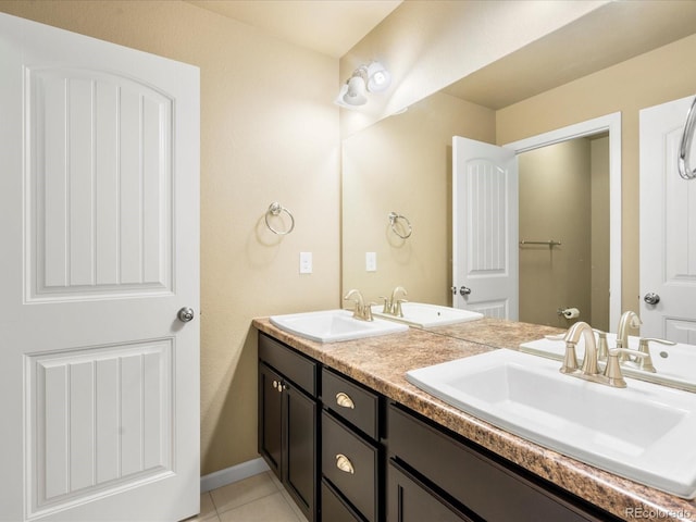 full bath with tile patterned floors, double vanity, and a sink