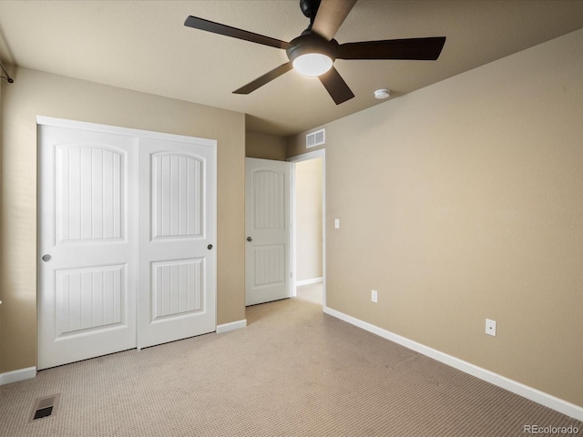 unfurnished bedroom with visible vents, baseboards, a closet, and carpet flooring