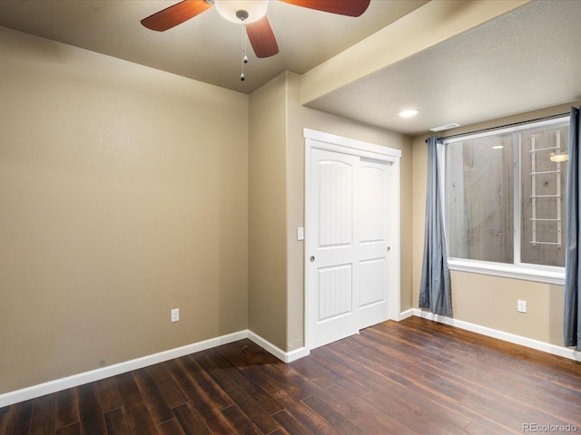 unfurnished bedroom with baseboards, wood finished floors, and a ceiling fan