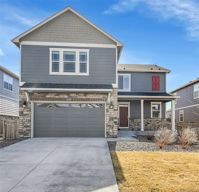 view of front of property featuring concrete driveway, a garage, covered porch, and stone siding