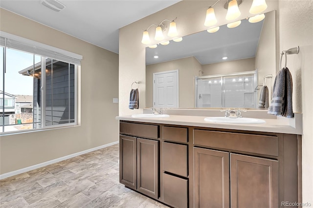 bathroom featuring a sink, visible vents, double vanity, and a shower stall