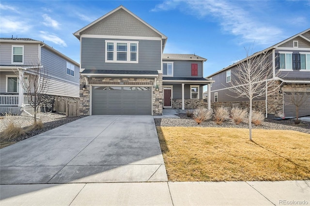 craftsman inspired home featuring a porch, concrete driveway, stone siding, and a front lawn