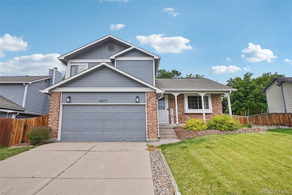 6017 S Pierson St, Littleton, CO 80127 - traditional-style home featuring concrete driveway and brick siding