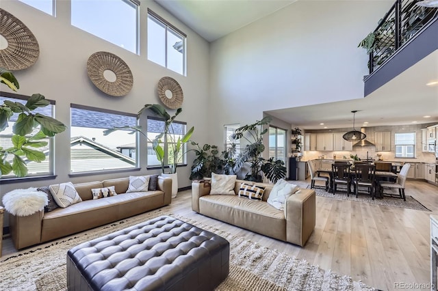 16345 Spanish Peak Way, Broomfield, CO 80023 - living area with light wood-type flooring, a towering ceiling, and recessed lighting