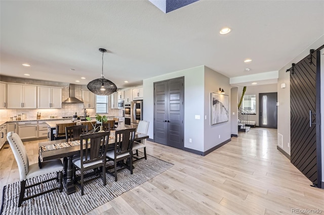 16345 Spanish Peak Way, Broomfield, CO 80023 - dining area with light wood finished floors, baseboards, recessed lighting, and stairway