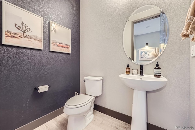 16345 Spanish Peak Way, Broomfield, CO 80023 - bathroom with toilet, wood finished floors, and baseboards