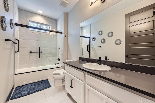 16345 Spanish Peak Way, Broomfield, CO 80023 - bathroom featuring toilet, tile patterned floors, shower / bath combination with glass door, and vanity