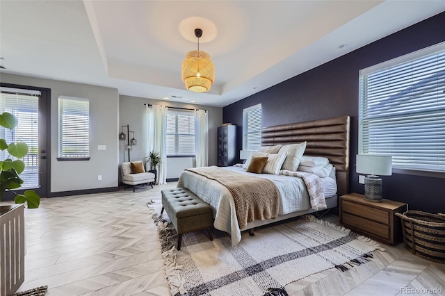 16345 Spanish Peak Way, Broomfield, CO 80023 - bedroom with a tray ceiling, access to exterior, and baseboards