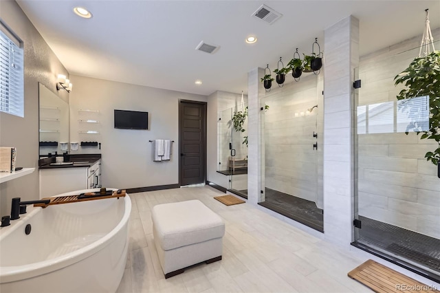 16345 Spanish Peak Way, Broomfield, CO 80023 - full bathroom with a shower stall, a freestanding tub, recessed lighting, and vanity