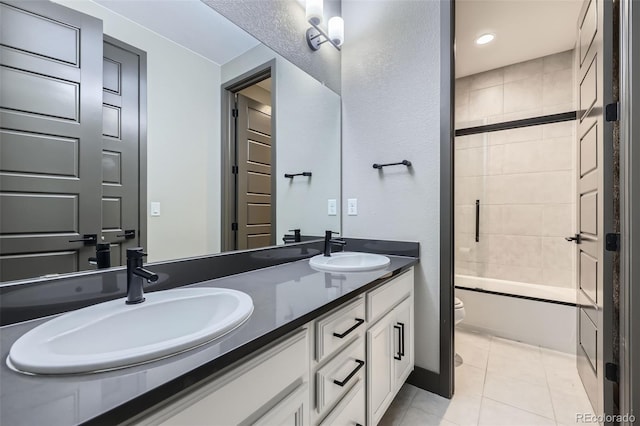 16345 Spanish Peak Way, Broomfield, CO 80023 - full bath featuring toilet, tile patterned flooring, double vanity, and shower / washtub combination