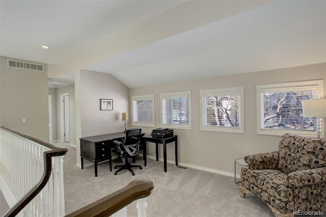 office space featuring lofted ceiling, light colored carpet, and a healthy amount of sunlight