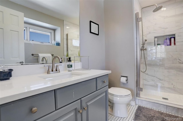 bathroom with vanity, toilet, and a shower with shower door