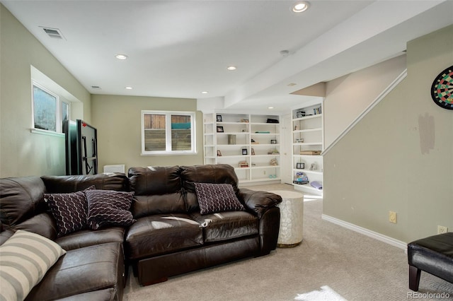 living room with light colored carpet and built in features