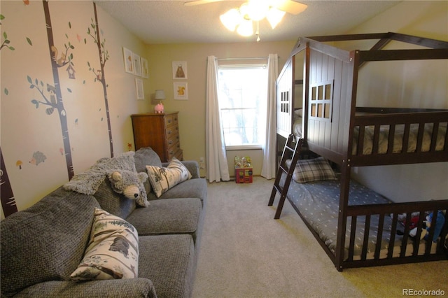 bedroom featuring ceiling fan, light carpet, and a textured ceiling