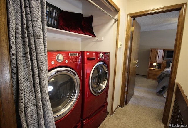 washroom with laundry area, light carpet, separate washer and dryer, and a textured ceiling