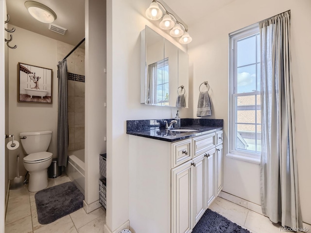 full bathroom with visible vents, toilet, vanity, and shower / bath combo with shower curtain