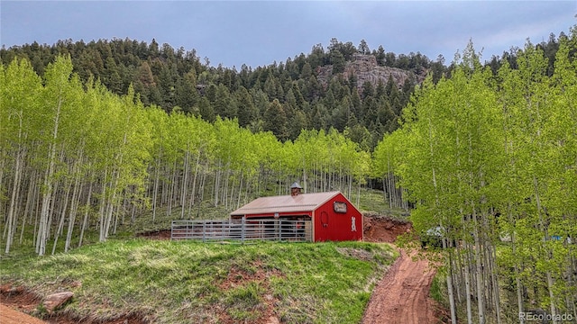 18766 State Highway 67, Divide, CO 80814 - view of yard featuring a wooded view, an outdoor structure, and a pole building